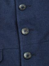 Close-up of a Blue de Gênes Casella Officers Blazer - Dark Navy in brushed cotton, showcasing three vertically-aligned black buttons with de ce que je inscribed in gold, resembling vintage parade uniforms.
