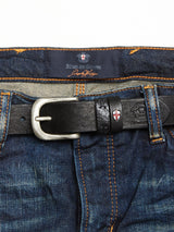 Close-up of vintage-style blue denim jeans with orange handmade stitches and featuring a Barra Belt - Black, characterized by a silver buckle. The waistband showcases a label from Blue de Gênes next to an embroidered emblem.