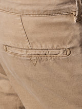 Close-up of the Teo Chino - Antique Bronze trousers by Blue de Gênes shows a back pocket with a horizontal slit and subtle V-shaped stitching. The honeycomb fabrics textured pattern and fine seam stitching give it a vintage look.