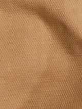 Close-up of Blue de Gênes Teo Chino in Antique Bronze: a honeycomb fabric with a warm golden-brown hue, detailed woven pattern, vintage appearance, subtle sheen, and rich depth.