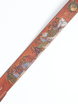 The Da Vinci Belt 4 cm - Brown by Blue de Gênes features a stunning embossed design inspired by The Last Supper, crafted in premium leather with intricate depictions of figures at a table against a light background, reflecting Leonardo Da Vincis artistic brilliance.