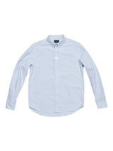 The Sandro Oxford Shirt by Blue de Gênes features light blue and white pinstripes, long sleeves, a pointed collar, and is crafted from organic cotton. It is showcased neatly laid flat on a white background, highlighting the front view.
