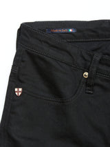 Close-up of Blue de Gênes Repi Stay Black Jeans crafted from comfort stretch denim, featuring a slim-fit design, a front pocket with an emblem, a metal button, and a Made in Italy label.