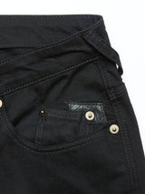 This close-up of Blue de Gênes Repi Stay Black Jeans highlights a black denim pocket with gold rivets, a small coin pocket, visible stitching, and a belt loop. The textured fabric enhances the comfort stretch denim ideal for slim-fit jeans.