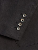 Close-up of the Leopardi Carbonio Blazer sleeve by Blue de Gênes in black, showcasing four buffalo horn buttons with metallic sheen and subtle engravings, set on Italian brushed cotton fabric for a smooth, polished look.