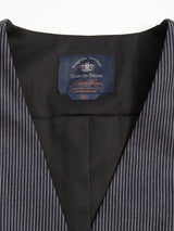 Close-up of a dark pinstripe suit jacket with a Blue de Gênes label, size 50. Made from a cotton-linen blend, it complements the Canna Pallone Gillet - Navy Stripe perfectly, set against a light background.