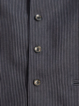 Close-up of the Canna Pallone Gillet - Navy Stripe by Blue de Gênes, featuring dark pinstripe cotton-linen fabric with thin white stripes and three metallic four-hole buttons. A partial pocket is visible at the bottom right.