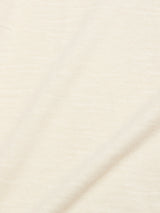 Close-up of BGmonty Knit - Chalk by Blue de Gênes, a soft, light beige cotton linen blend fabric featuring a subtle diagonal crease and fine, smooth texture. The material is lightweight and slightly stretchy.