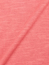 Close-up of BGmonty Knit - Coral by Blue de Gênes, a soft pink cotton-linen blend fabric with a diagonal fold that highlights its subtle texture and weave pattern.