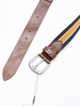The Blue de Gênes BGcollege Belt - Navy Stripe features a brown leather buckle attachment and a navy blue and yellow striped strap, shown on a white background with a white tag hanging from the silver buckle.