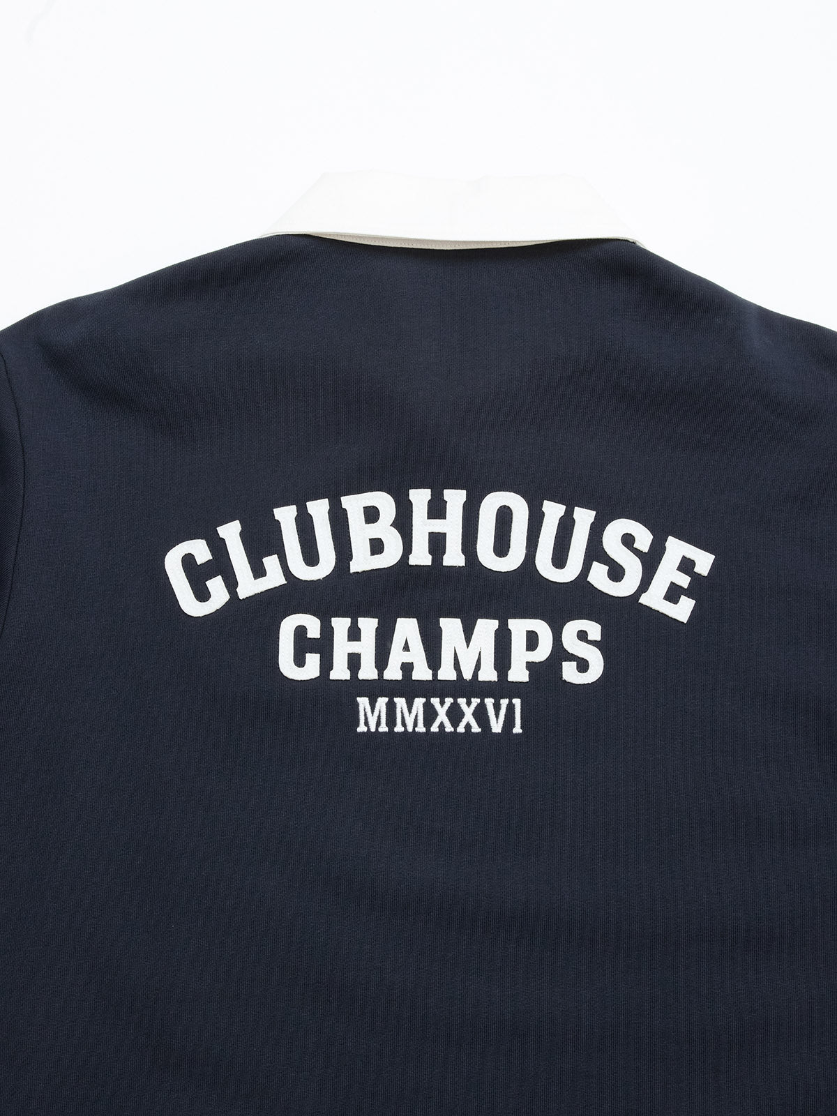 Introducing the BGclubhouse Rugby Sweatshirt in navy by Blue de Gênes—a soft cotton jersey piece inspired by athletic heritage, featuring a white collar and bold “CLUBHOUSE CHAMPS MMXXVI” text in white on the back.