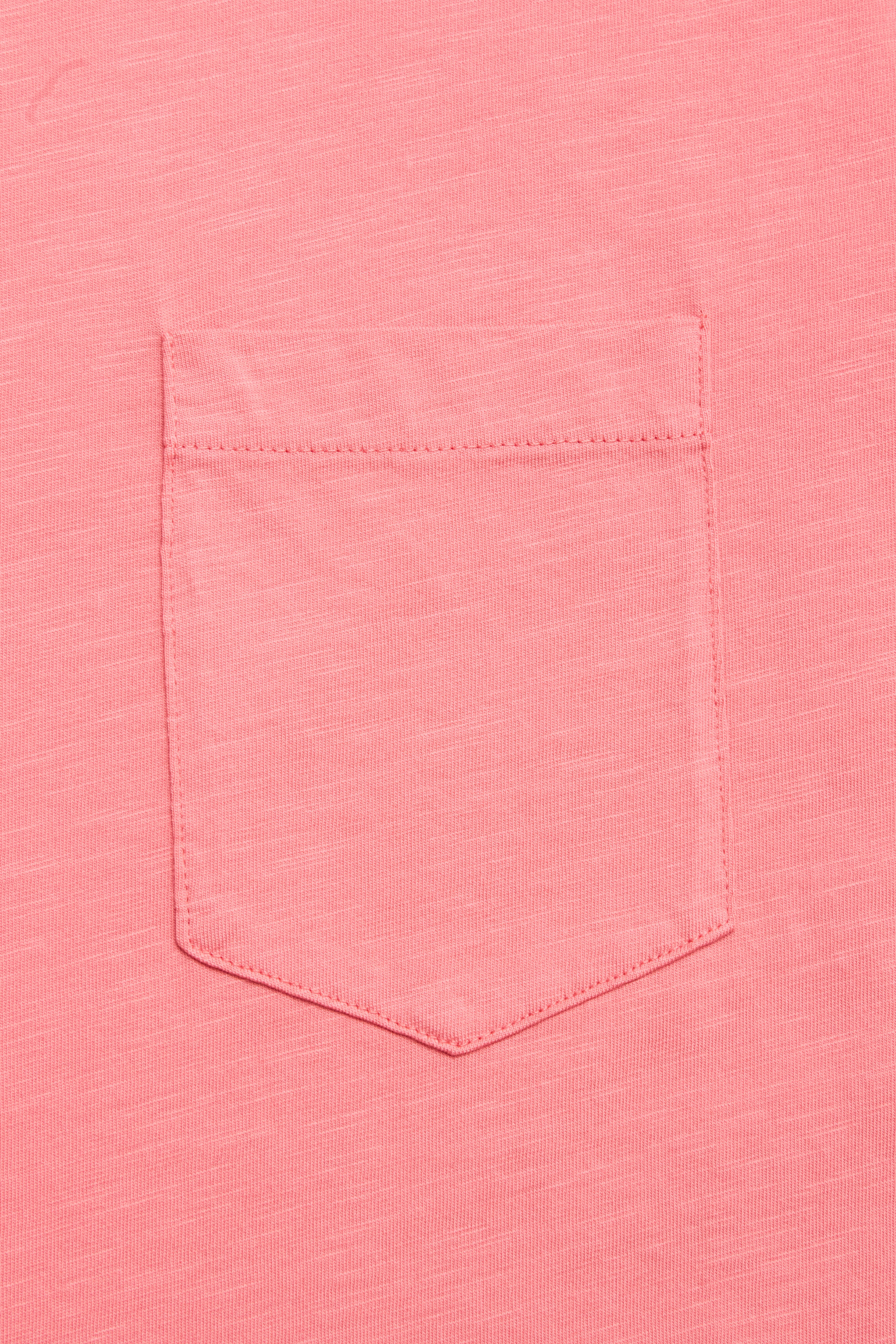 A close-up of the BGoscar T-Shirt - Coral by Blue de Gênes, featuring a classic crewneck and single chest pocket with visible stitching, made from 100% cotton.