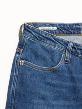 Close-up of BGrepi Kanto Jeans - Used by Blue de Gênes in blue comfort stretch denim, highlighting the pocket area, a small shield emblem near the pocket, and a Made in Italy label with the Italian flag on the waistband.