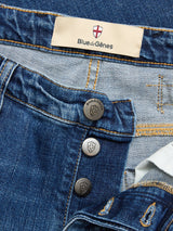 Close-up of BGrepi Kanto Jeans - Used by Blue de Gênes, made from comfort stretch denim with visible stitching, three shield-engraved metal buttons, and a beige “Blue de Gênes” label.