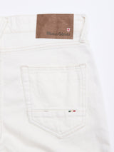Close-up of the back pocket on Blue de Gênes BGvinci Bianco Jeans in white, showing a brown leather brand patch and a small embroidered Italian flag detail above the pocket.