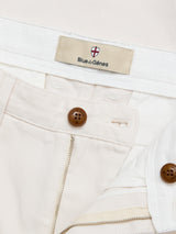 Close-up of BGpalco Twill Pants in the Chalk colorway by Blue de Gênes, featuring a relaxed fit in durable cotton twill, with a visible zipper, brown buttons, and a Blue de Gênes label on the waistband for comfort and longevity.