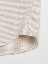 Close-up of the hem of the Blue de Gênes BGbasso Meco Shirt - Beige Stripe, showing its rounded edge, side slit, and visible stitching. Made in Portugal with beige and white vertical stripes.