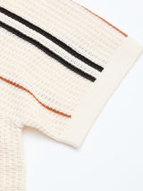 Close-up of the BGwalter S/S Cardigan in Chalk by Blue de Gênes, a cream-colored short sleeve knit cardigan crafted from 100% cotton with a subtle lace knit pattern, featuring black and brown horizontal stripes near the hem, shown on a white background.
