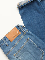 Two pairs of BGrepi Misto Jeans - Med Used by Blue de Gênes are displayed on a white surface, perfect for testing out your denim style. One pair features a brown leather patch on the waistband with the Blue de Gênes logo.