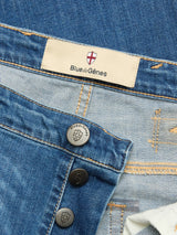 Close-up of BGrepi Misto Jeans - Med Used by Blue de Gênes, highlighting the brand label, exposed test-branded buttons, and detailed stitching.