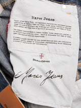 White cloth label inside BGmarco Rowan Jeans - Used by Blue de Gênes, featuring relaxed fit details, the Blue de Gênes logo, and a cursive "Marco Jeans" signature. Surrounding denim fabric is visible.
