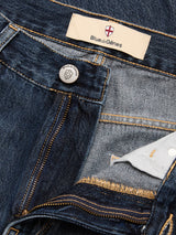 Close-up of blue denim BGmarco Rowan Jeans - Used by Blue de Gênes, showing the fly partially unzipped to reveal inner fabric and a Blue de Gênes label with a small crest inside the waistband.