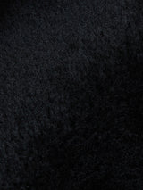 Close-up of the Rufo Shearling Jacket - Scarab by Blue de Gênes, highlighting its textured black plush lining with visible fine fibers and a soft, slightly wavy appearance.