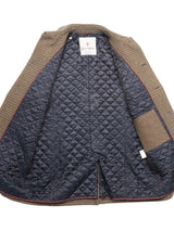 The Massone Check Coat - Multi Check by Blue de Gênes is an open winter coat with a brown and tan check pattern, navy blue quilted lining, interior pocket, and a white label on the upper back—ideal Italian wool for cold days.