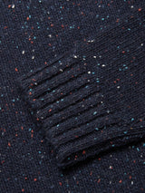 A close-up of the Honshu Crewneck Knit - Navy by Blue de Gênes, showcasing the chunky knit sleeve with colorful red, white, and blue flecks woven throughout the lambswool blend fabric.
