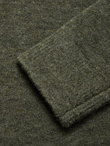 A close-up view of a folded sleeve on the Malakka Polo Knit - Army sweater by Blue de Gênes, highlighting the soft, textured olive green wool blend fabric.