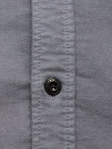 Close-up of a Dark Slate Nagano Overshirt by Blue de Gênes in garment-dyed cotton moleskin, featuring a vertical seam and a single dark button with “LANDS END” text around the edge.
