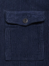 Close-up of the Masami Cord Blazer - Navy by Blue de Gênes, featuring garment dyed navy corduroy with visible vertical ridges and a rectangular flap pocket secured by a black button.