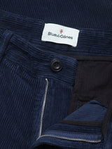 Close-up of the Etsu Cord Chino - Navy by Blue de Gênes, featuring a relaxed regular fit crafted from soft 7-wale corduroy, with a visible zipper and button, detailed inner waistband, and a signature white Blue de Gênes label sewn inside.