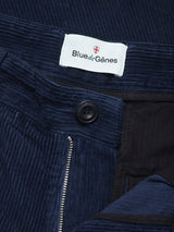 Close-up of the Blue de Gênes Etsu Cord Chino - Navy pants, featuring dark blue 7-wale corduroy fabric with a visible zipper, black button, and a white Blue de Gênes label on the waistband, highlighting their relaxed regular fit.