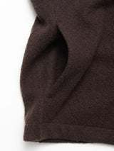 Close-up of the Blue de Gênes Koi Wool Gilet - Chocolate, showing its brown textured boiled wool and curved seam, laid out on a white background.