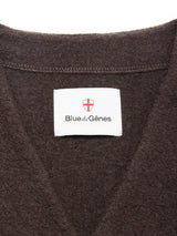 Close-up of the Koi Wool Gilet - Chocolate by Blue de Gênes, showing brown boiled wool and a white collar label featuring a red shield, the brand name, and detailed edge stitching.
