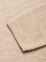 A close-up of the Toyama Knit L/S - Oat by Blue de Gênes, highlighting the sleeve and body with its textured, woven pattern, expertly knitted in Denmark.