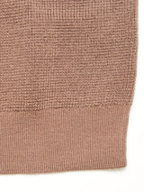 Close-up of the Porto Polo Knit - Fungi by Blue de Gênes, a light brown, textured luxury knitwear fabric featuring a ribbed hem, displayed against a white background.