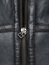 Close-up of the Saga Shearling Gilet in Scarab by Blue de Gênes, crafted from German Merino sheepskin with a visible central zipper and textured, stitched leather panels on either side.