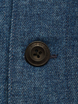 Close-up of the Yuma Fano Jacket - Denim Blue by Blue de Gênes, showing its sturdy denim fabric and a black four-hole button engraved "Blue de Gênes," highlighting the quality typical of this heavy cotton blend.