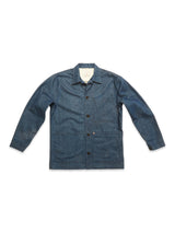 The Blue de Gênes Yuma Fano Jacket in Denim Blue is a relaxed-fit, long-sleeve button-up with a collar and two large front pockets, shown laid flat on a white background.