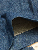 Close-up of a folded section of the Blue de Gênes Shogun Fano Pant in Denim Blue, showcasing the inside weave and texture typical of contemporary heavy cotton construction, with a portion of the lighter, unfinished edge visible.