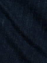 Close-up of BGvinci Girisha Rinse Jeans by Blue de Gênes, featuring dark blue comfort stretch denim with visible weave texture and a diagonal seam, characteristic of rinse wash regular fit jeans.