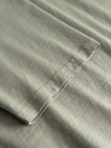 Close-up of shadow green slub cotton fabric from the BGoscar T-Shirt by Blue de Gênes, showcasing neatly stitched seams, textured weave, and high-quality craftsmanship.