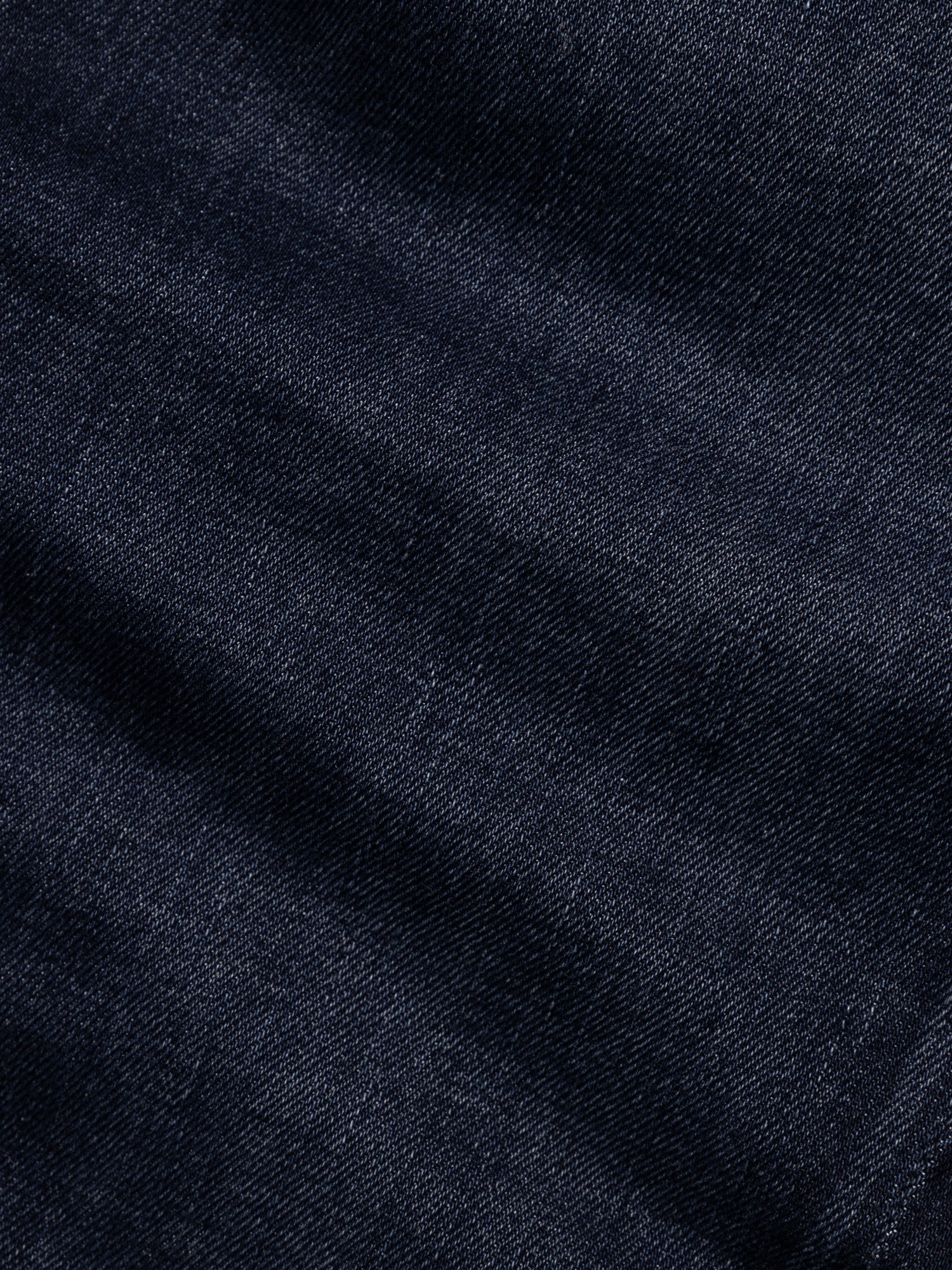Close-up of the BGvinci Pala Dark V2 Jeans by Blue de Gênes in dark blue denim, featuring comfort stretch fabric with a textured weave and subtle creases—ideal for regular fit jeans.