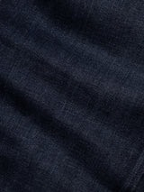 Close-up of the BGvinci Pala Dark V2 Jeans by Blue de Gênes in dark blue denim, featuring comfort stretch fabric with a textured weave and subtle creases—ideal for regular fit jeans.