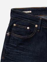 Close-up of the BGvinci Pala Dark V2 Jeans in dark blue comfort stretch denim by Blue de Gênes, featuring yellow stitching, visible front and coin pockets, and a small Italy flag tag above the waistband. These regular fit jeans are made in Italy for exceptional quality and style.