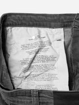 The inside of the BGrepi Giulio Light V2 Jeans - Grey Denim by Blue de Gênes is shown, featuring a white fabric label with paragraphs of black text about Renzo Piano, the renowned Italian architect.