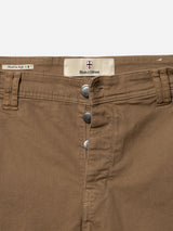 Close-up of fudge BGpaulo Pavia 1 V2 Chino by Blue de Gênes, featuring cotton stretch fabric, three visible buttons, belt loops, and a label above the waistband—crafted in Italy in vintage military style.