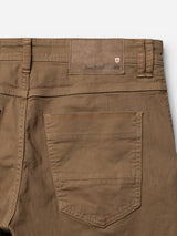 Close-up of the back of the BGpaulo Pavia 1 V2 Chino - Fudge by Blue de Gênes, showing a pocket, belt loops, and a leather patch embossed with Blue de Gênes and a small shield logo in the top corner.